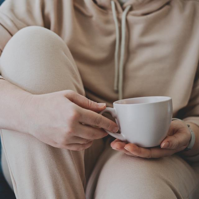 A mother sits on her own thinking about modeling behavior with her child