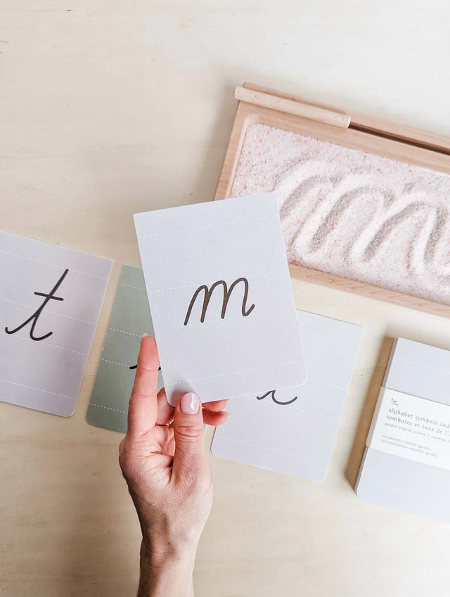 Montessori alphabet flash cards in minimalist neutral colours showing the first letters you should introduce to your child using the Tim Seldin order of introducing letters